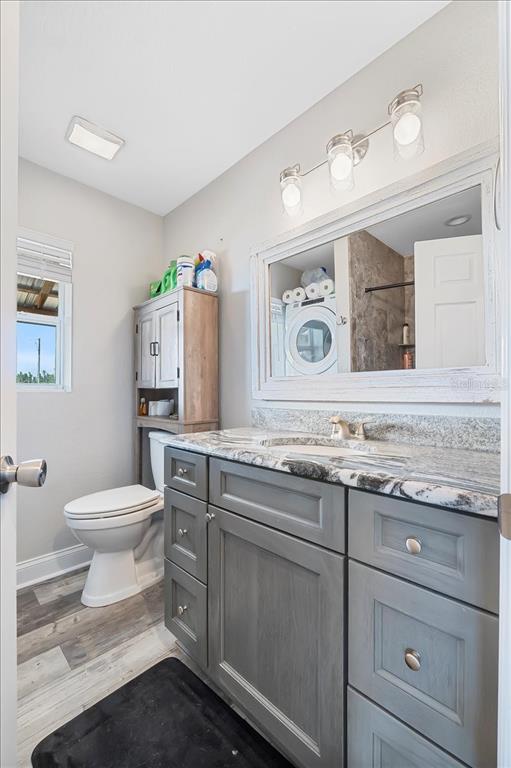 11657 Moore Road Lakeland, FL 33809 - Photo 77 of 100 a bathroom with a toilet sink and mirror