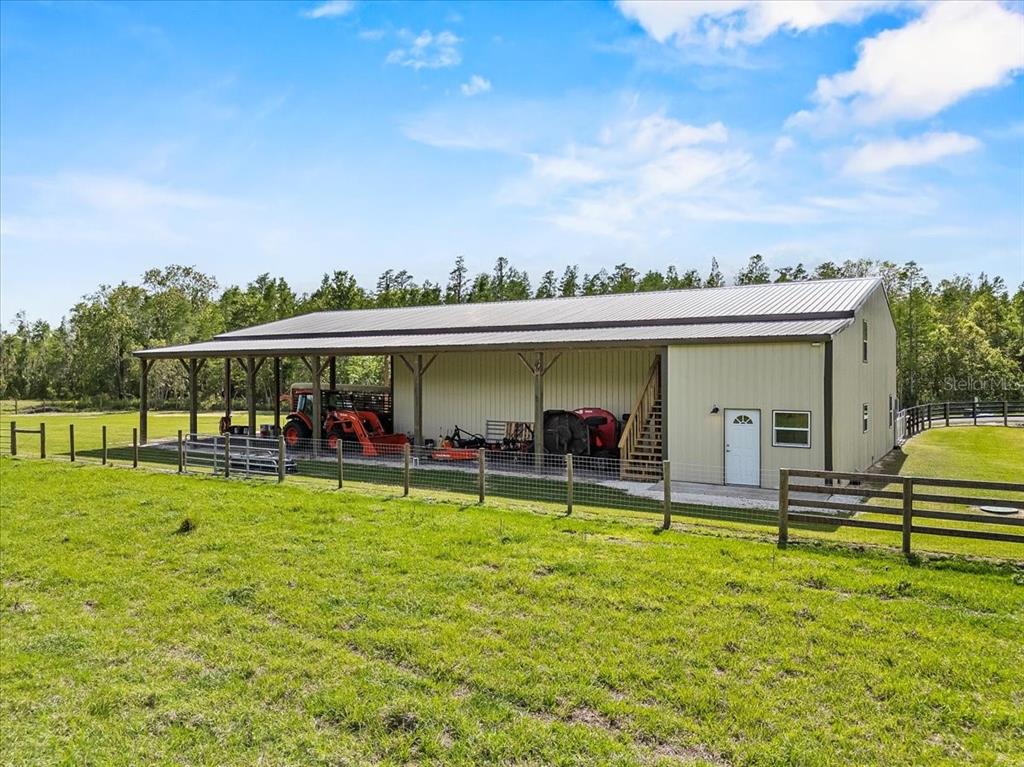 11657 Moore Road Lakeland, FL 33809 - Photo 86 of 100 a view of a swimming pool with lawn chairs and a big yard