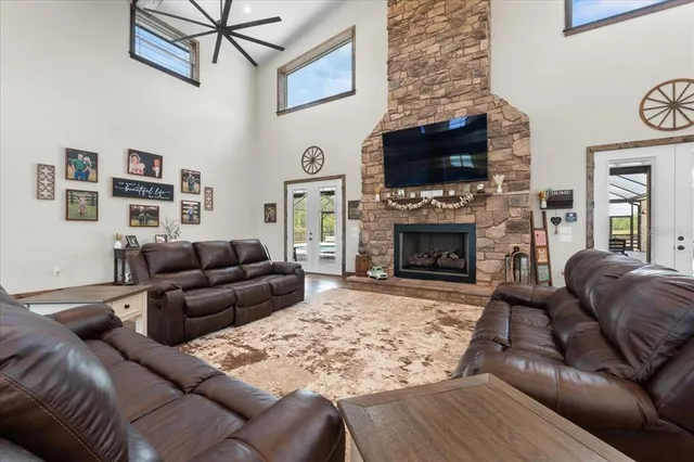 a large white kitchen with stainless steel appliances granite countertop a stove and a sink