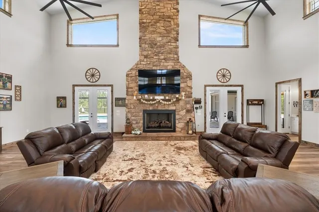 a living room with lots of furniture and wooden floors