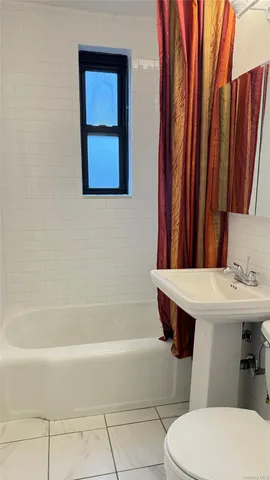a bathroom with a sink a toilet and bathtub