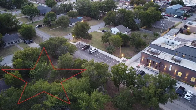 an aerial view of residential houses with outdoor space and street view