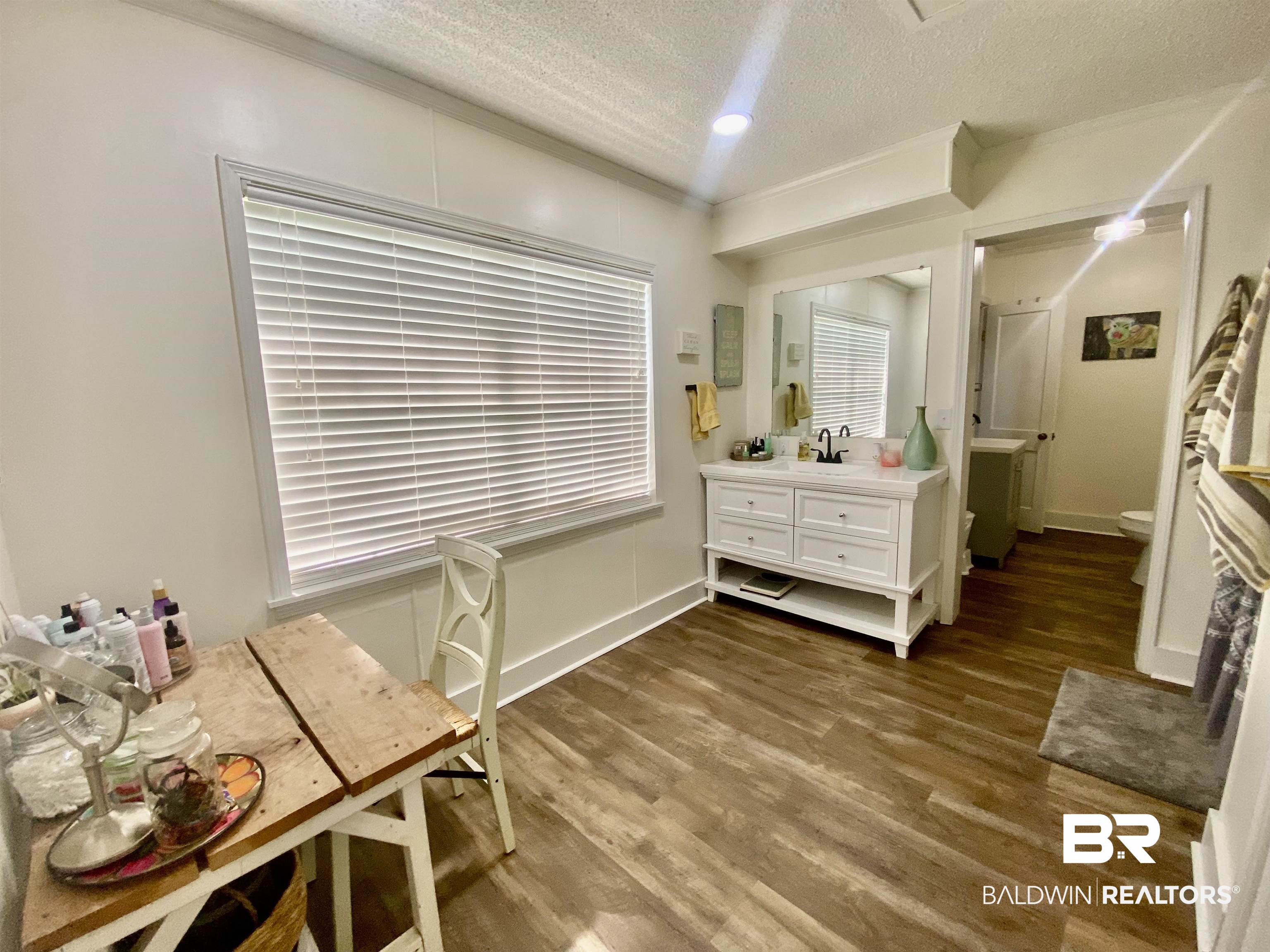 531 Highway 136 Monroeville, AL 36460 - Photo 30 of 48 Sitting room with sink, a textured ceiling, and hardwood / wood-style flooring