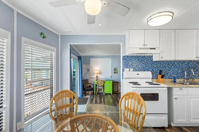 a kitchen that has a table and chairs in it