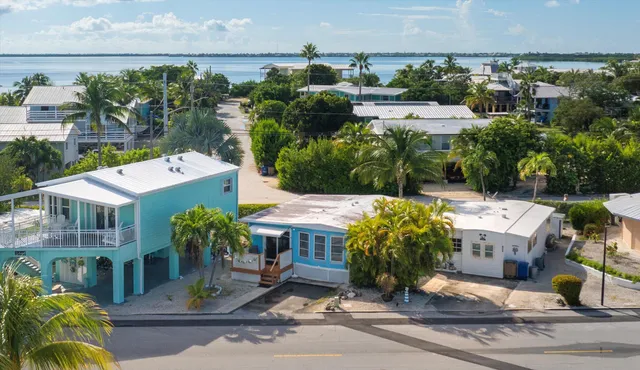 an aerial view of multiple houses with yard