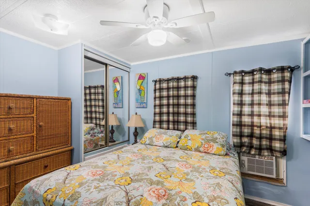 a bedroom with a bed dresser and window