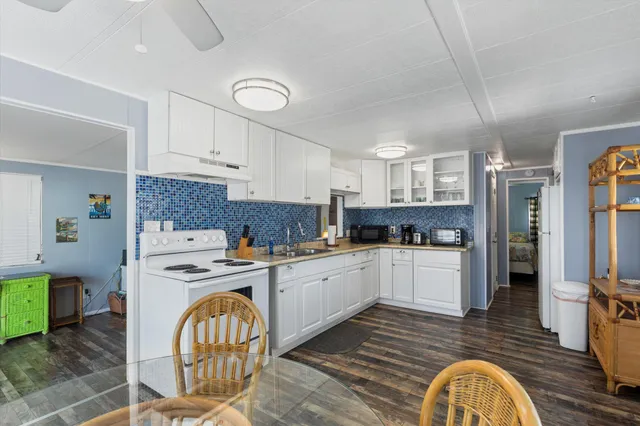 a kitchen with cabinets and wooden floor