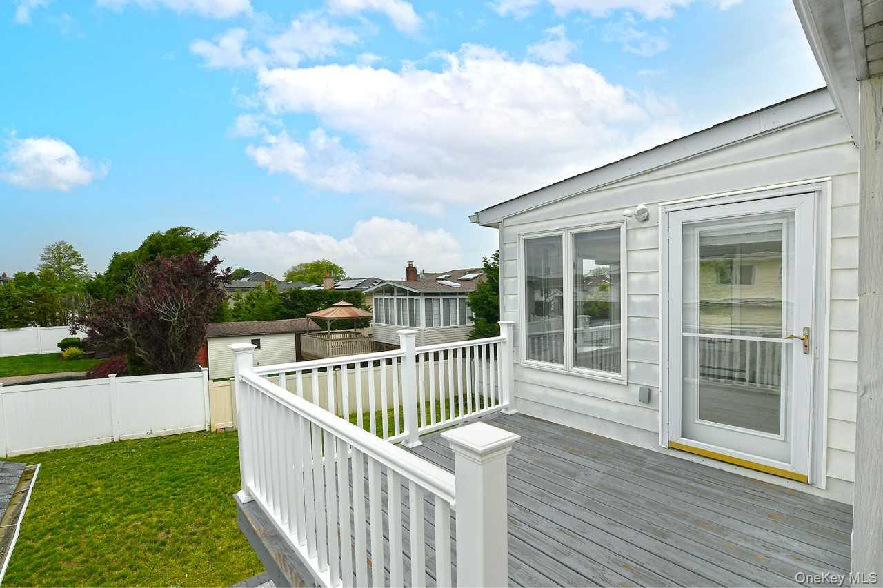 107 Beverly Road Massapequa, NY 11758 - Photo 27 of 41 a view of a deck with a yard
