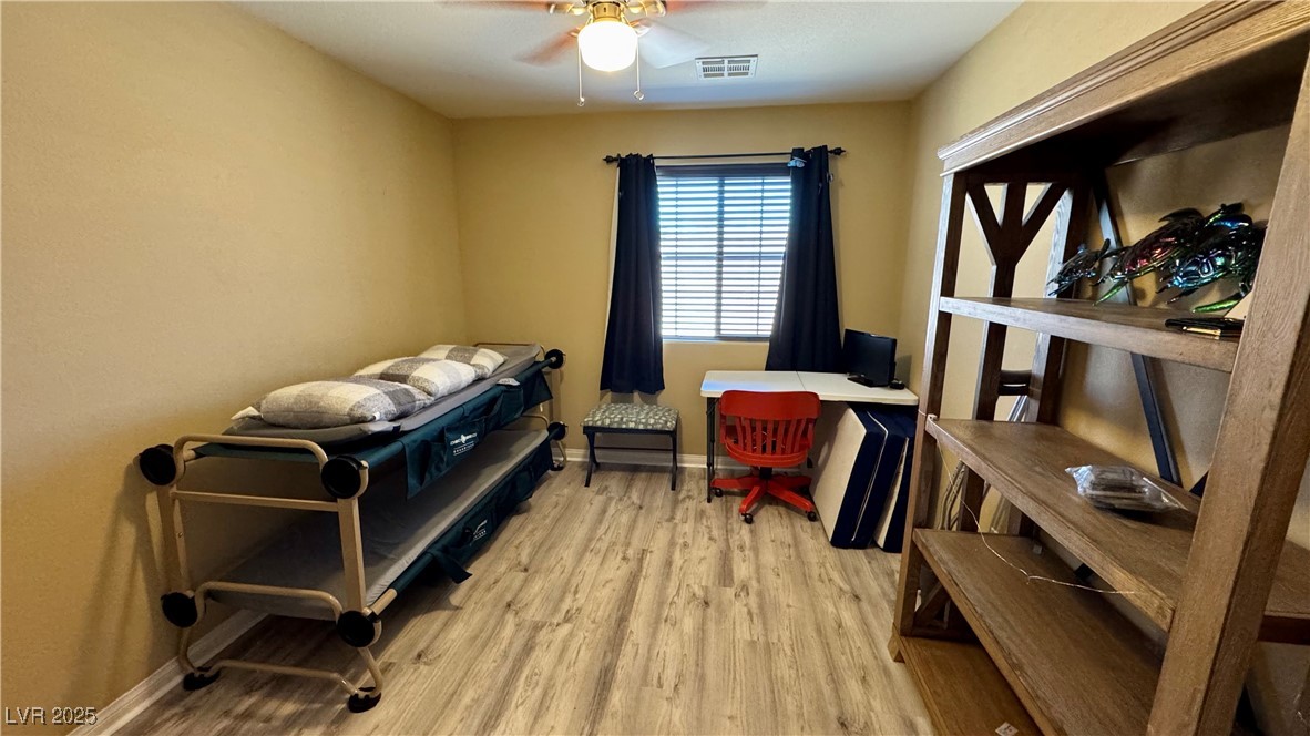 2293 Chandler Ranch Place Laughlin, NV 89029 - Photo 16 of 23 Bedroom with light wood-style flooring and a ceiling fan