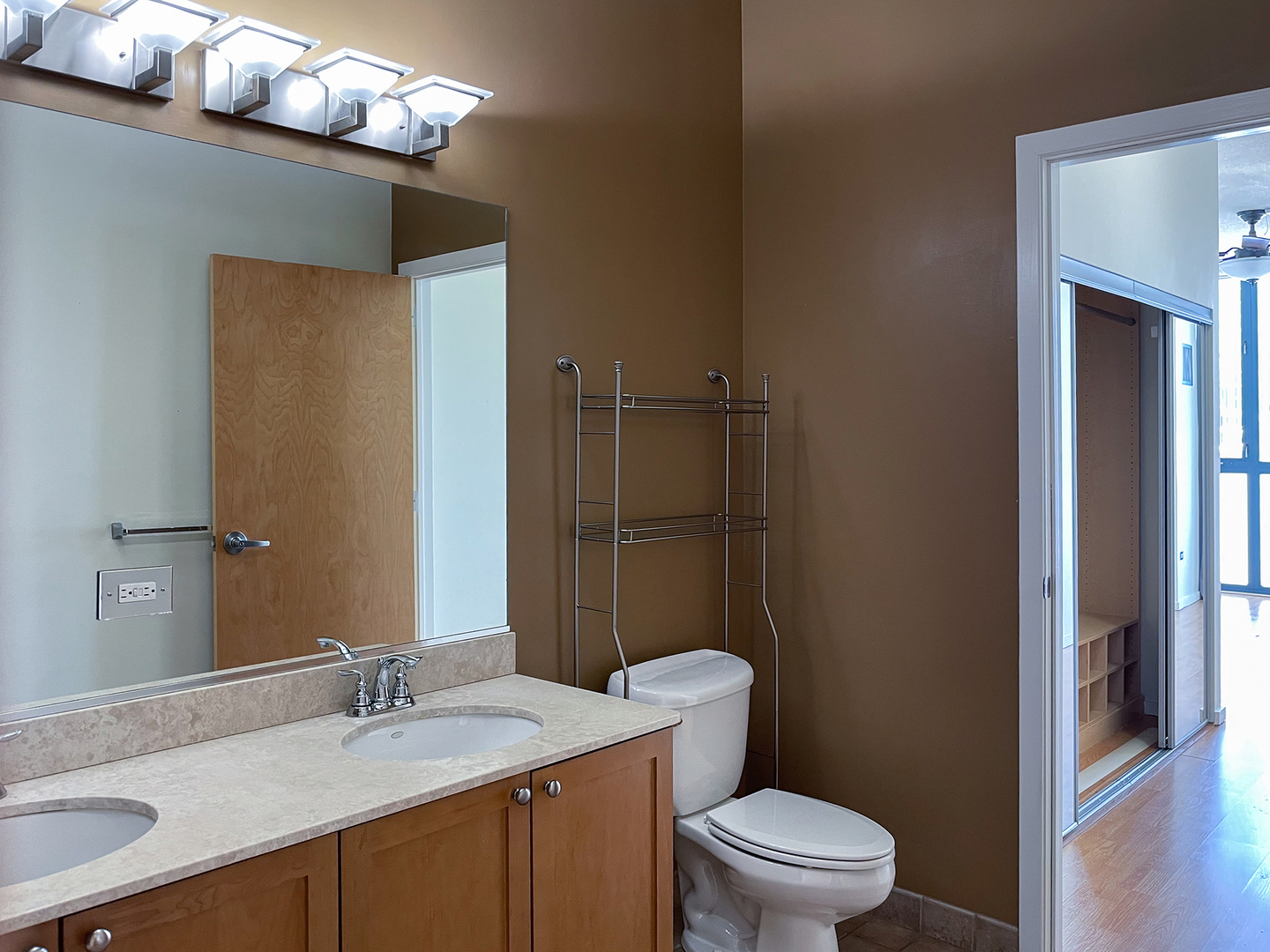321 South Sangamon Street, Unit 604 Chicago, IL 60607 - Photo 14 of 24 a bathroom with a sink a toilet a light fixture and mirror