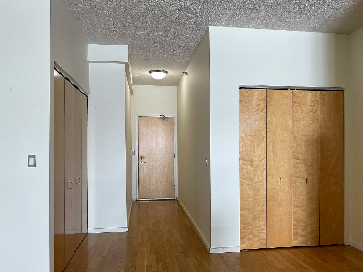 321 South Sangamon Street, Unit 604 Chicago, IL 60607 - Photo 5 of 24 a view of a hallway with wooden floor