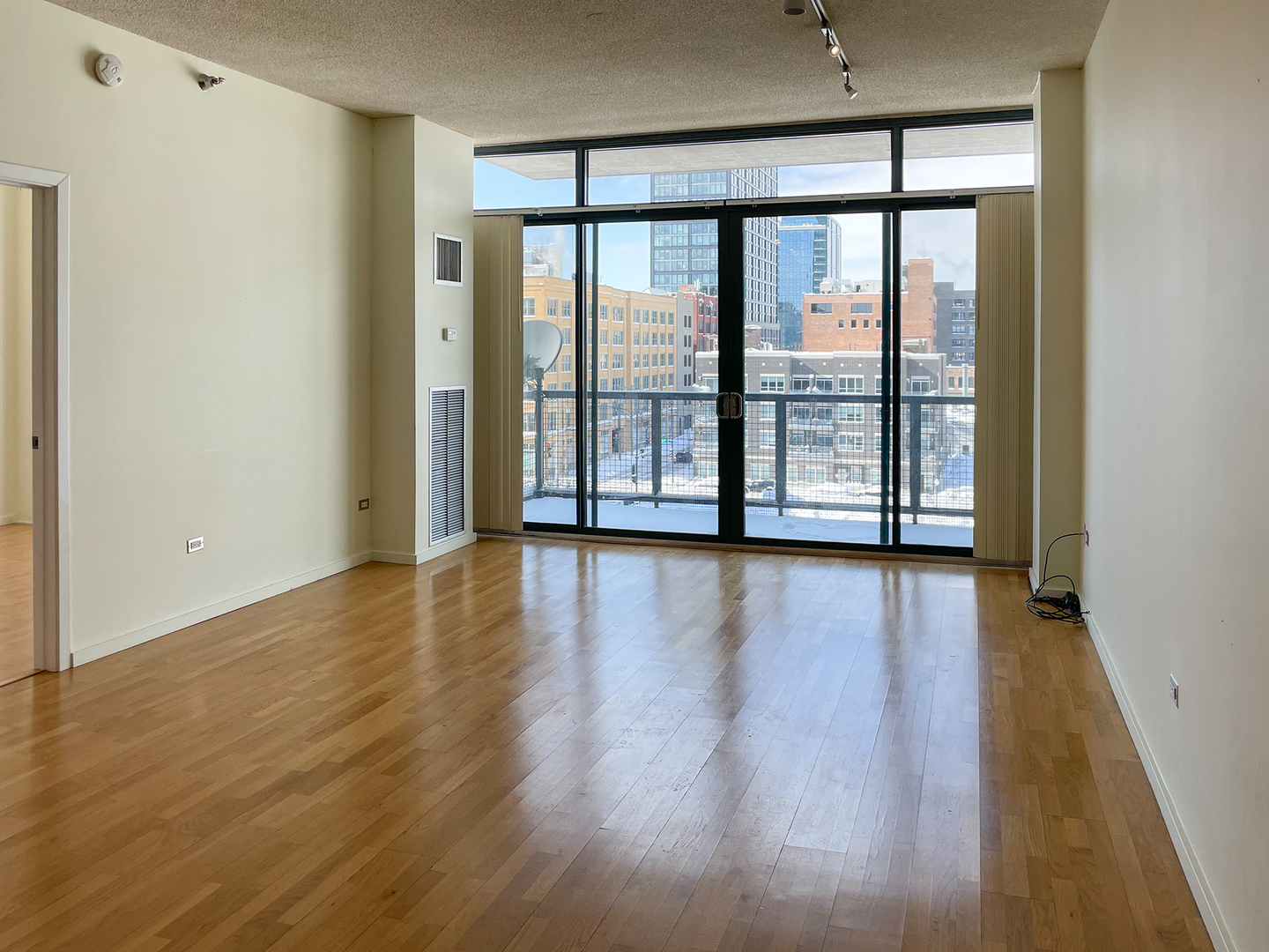 321 South Sangamon Street, Unit 604 Chicago, IL 60607 - Photo 6 of 24 a view of an empty room with wooden floor and a window