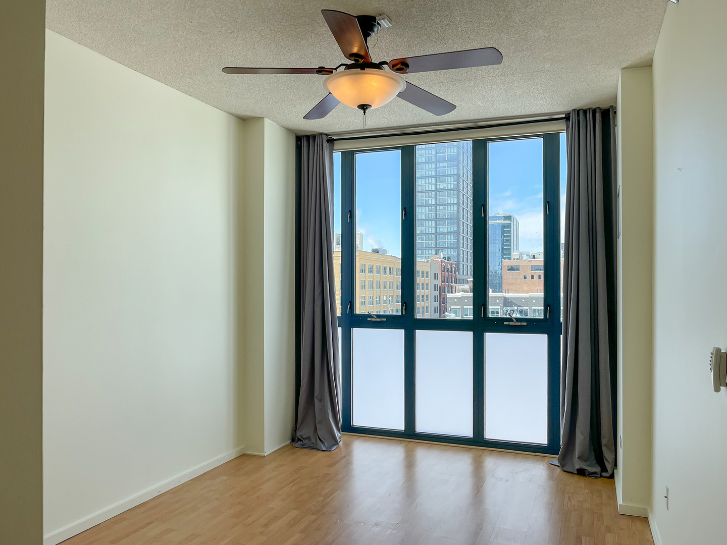 321 South Sangamon Street, Unit 604 Chicago, IL 60607 - Photo 10 of 24 a view of an empty room with window and wooden floor