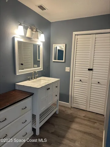 a bathroom with a double vanity sink and a mirror