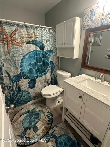 a bathroom with a sink toilet and mirror