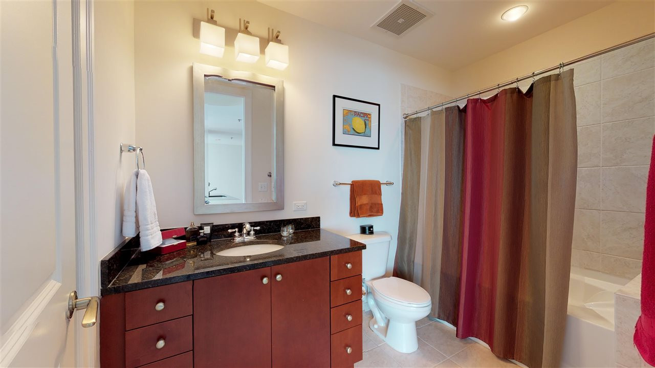 301 Fayetteville Street, Unit 2408 Raleigh, NC 27601 - Photo 12 of 19 Large bathroom with shower/tub and a well-lit vanity. Bathroom