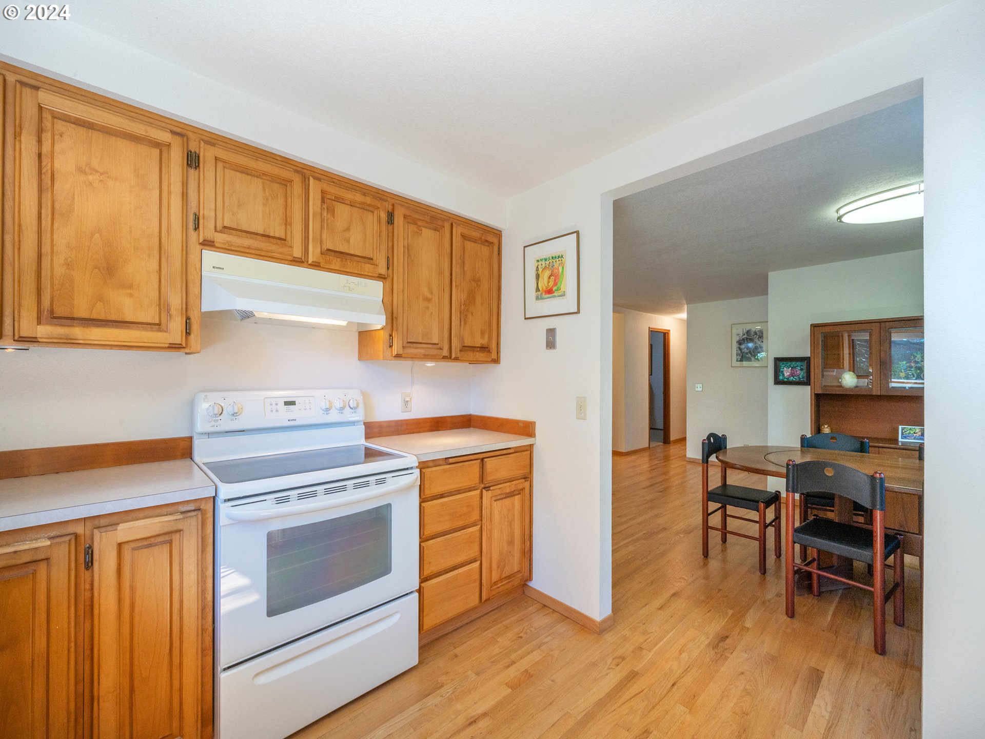 1778 West 27th Place Eugene, OR 97405 - Photo 14 of 43 a kitchen with a stove and white cabinets