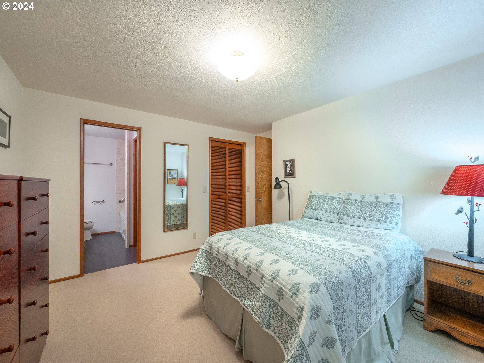 1778 West 27th Place Eugene, OR 97405 - Photo 16 of 43 a spacious bedroom with a bed and a closet