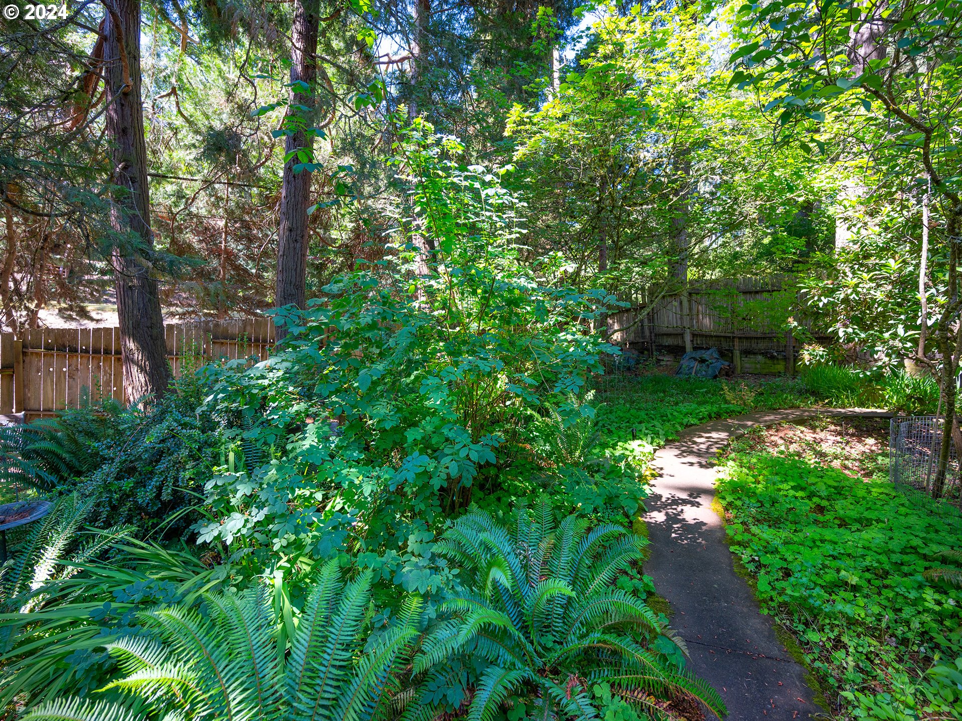 1778 West 27th Place Eugene, OR 97405 - Photo 38 of 43 a backyard of a house with lots of green space and fountain