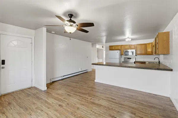 a view of a kitchen with a sink and wooden floor