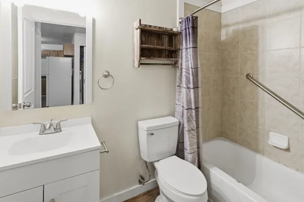 a white toilet sitting next to a bathroom sink