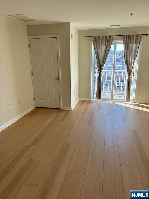 39 Union Street, Unit 301 Hackensack, NJ 07601 - Photo 7 of 14 an empty room with wooden floor and windows
