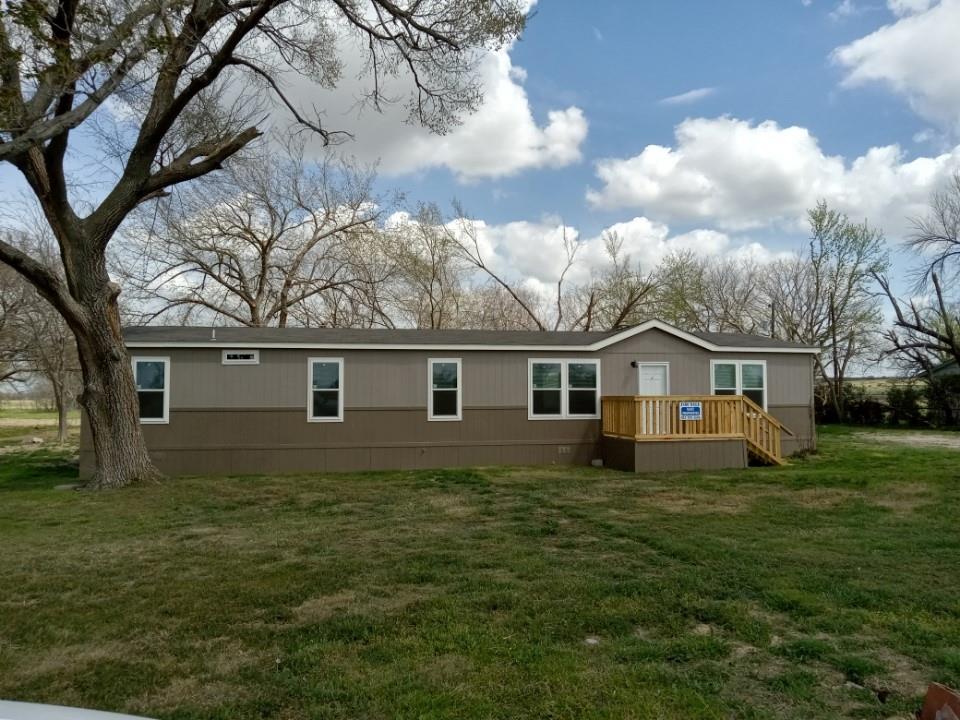 351 County Road 3585 Paradise, TX 76073 - Photo 1 of 1 a house that is sitting in the grass with large trees