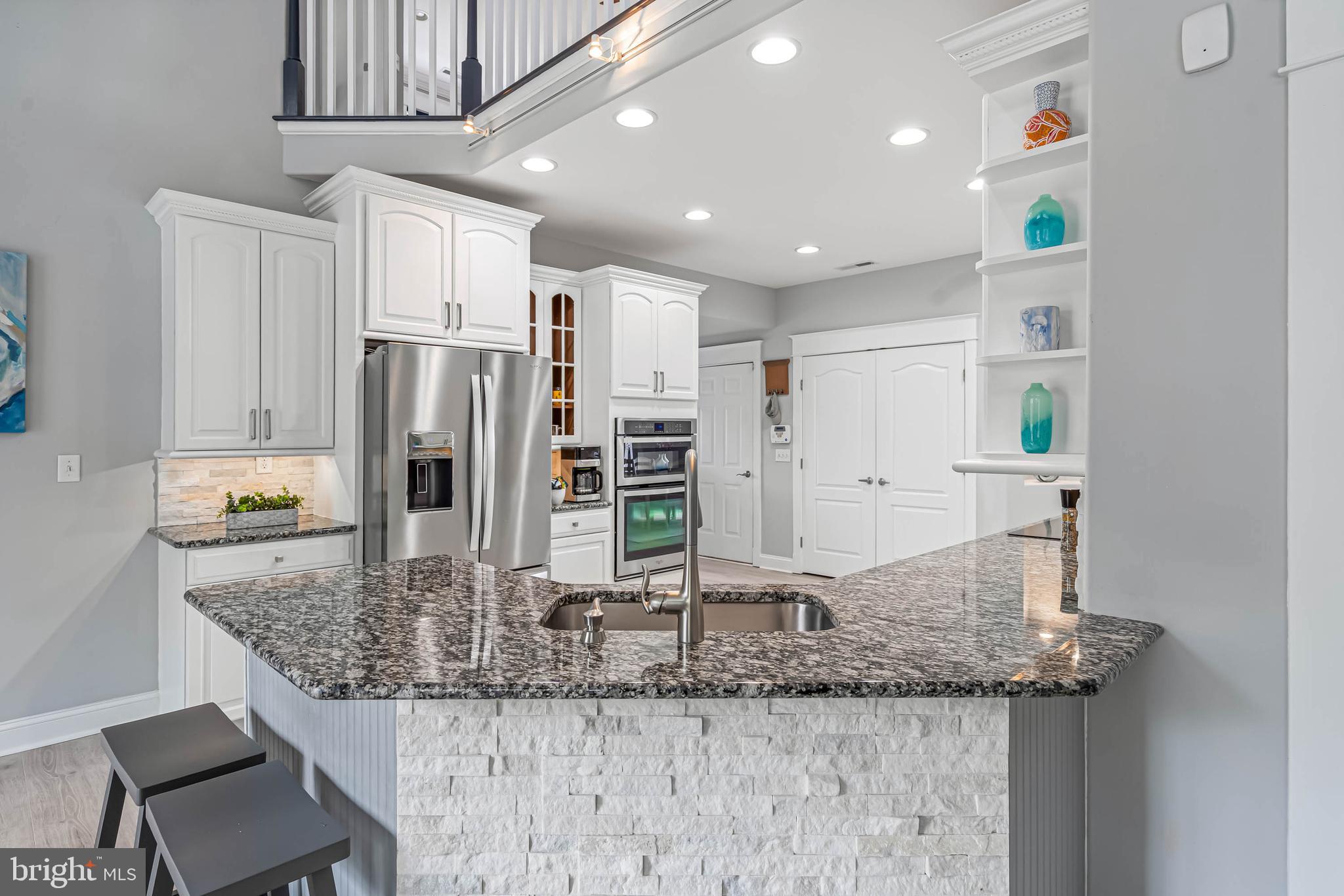 33096 Burbage Road Frankford, DE 19945 - Photo 12 of 53 a kitchen with stainless steel appliances granite countertop a sink and a refrigerator