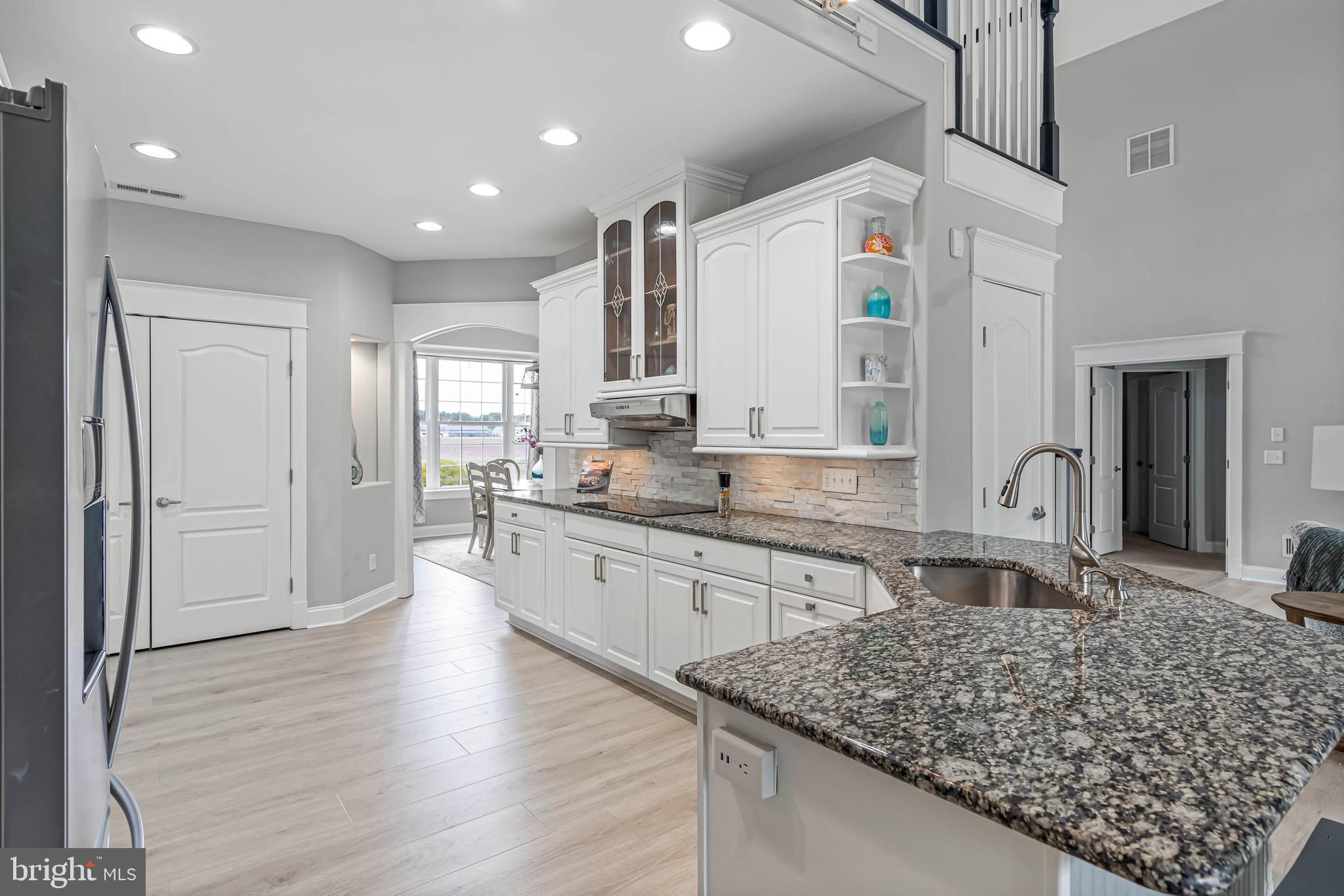 33096 Burbage Road Frankford, DE 19945 - Photo 13 of 53 a large kitchen with stainless steel appliances granite countertop a sink refrigerator and cabinets