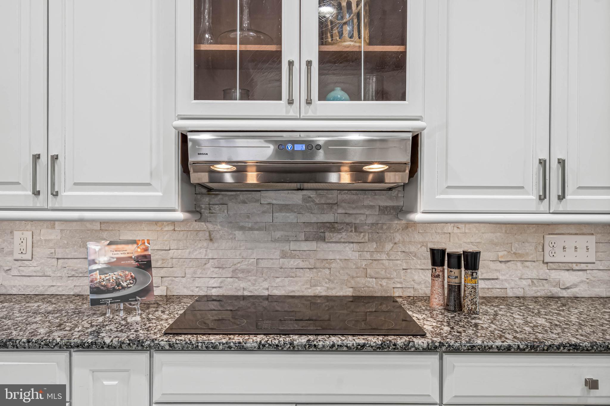 33096 Burbage Road Frankford, DE 19945 - Photo 15 of 53 a kitchen with granite countertop white cabinets and a stove
