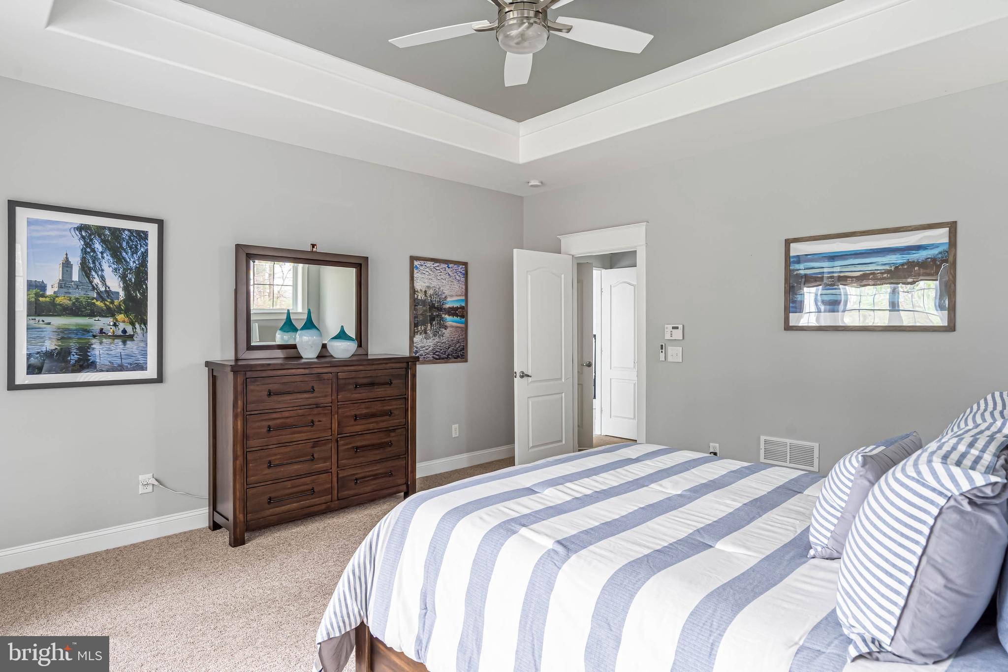 33096 Burbage Road Frankford, DE 19945 - Photo 26 of 53 a bedroom with a bed and a chandelier