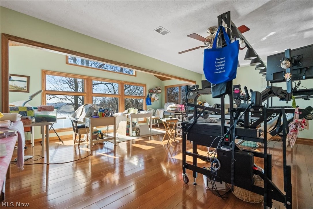 4280 Newbury Road Little Hocking, OH 45742 - Photo 22 of 41 Misc room featuring ceiling fan, a textured ceiling, and hardwood / wood-style flooring
