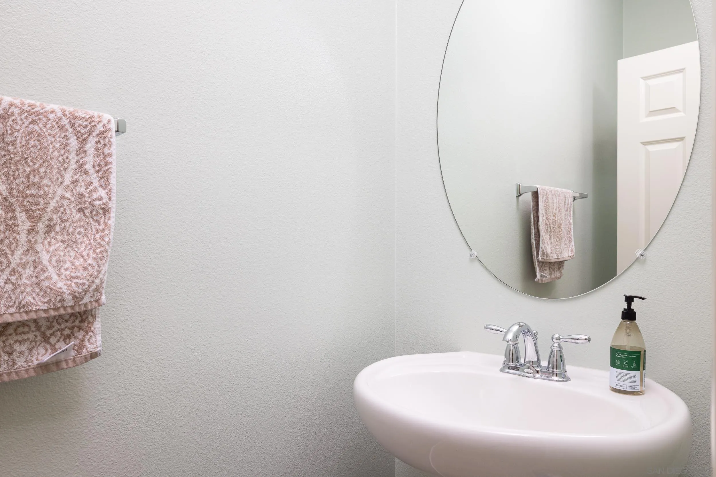 211 Spotted Saddle Way Fallbrook, CA 92028 - Photo 18 of 24 a bathroom with a sink and a mirror