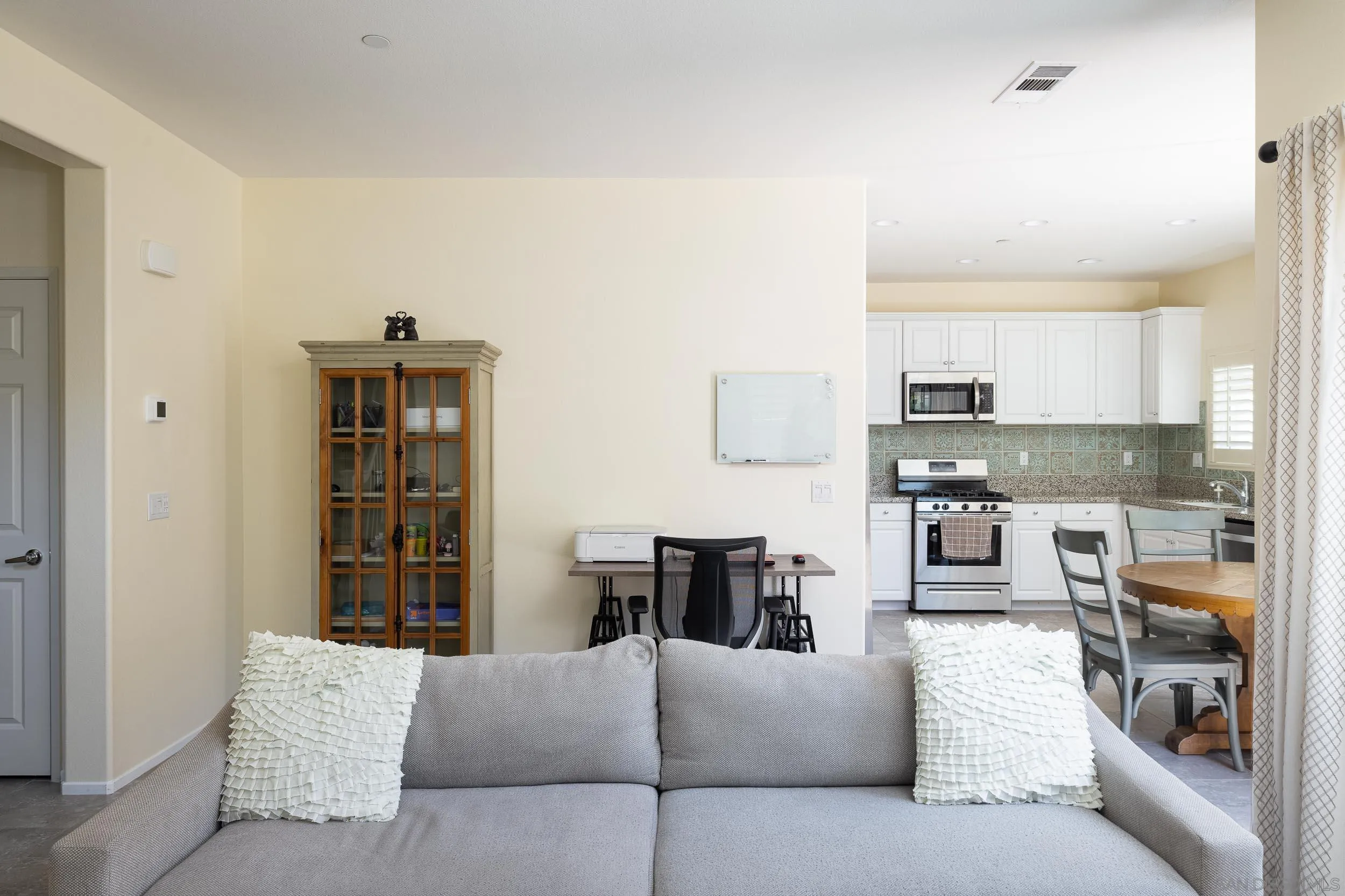 211 Spotted Saddle Way Fallbrook, CA 92028 - Photo 4 of 24 a living room with furniture and a kitchen area
