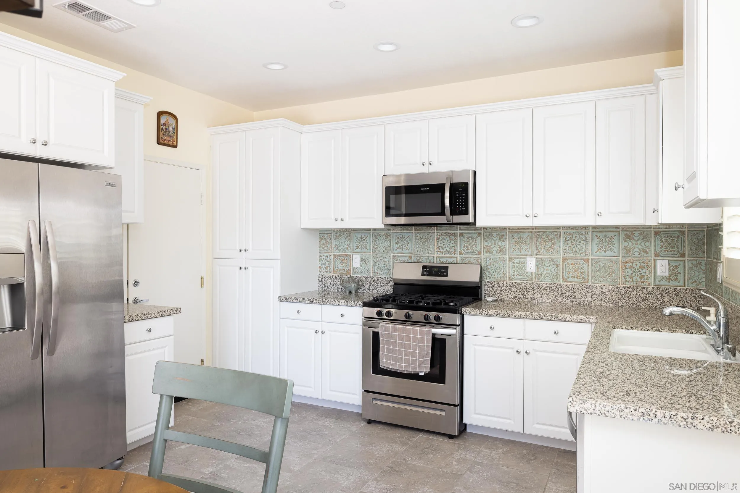 211 Spotted Saddle Way Fallbrook, CA 92028 - Photo 6 of 24 a kitchen with stainless steel appliances granite countertop a stove a sink and a refrigerator