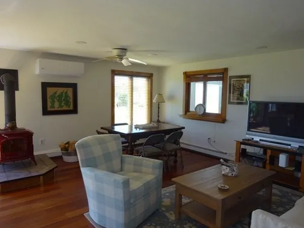 a living room with furniture and kitchen view