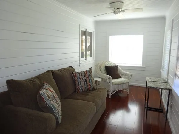 a living room with furniture a couch and a window