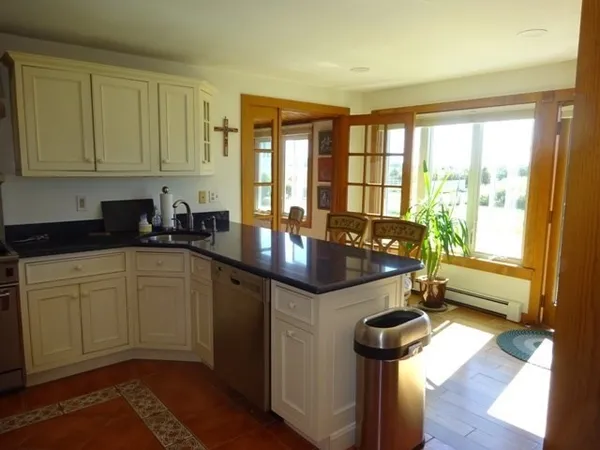 a kitchen with stainless steel appliances granite countertop a sink refrigerator and cabinets
