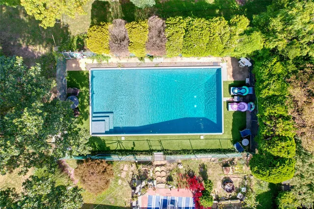 a green field with flowers and trees