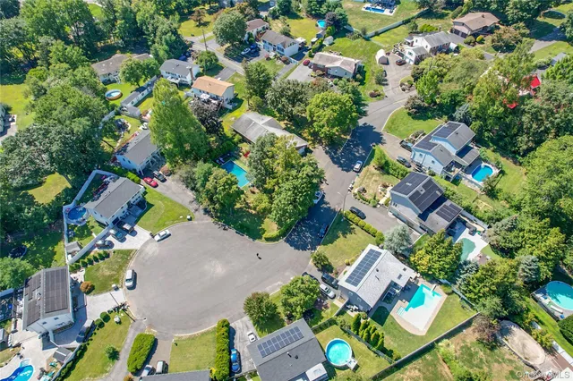 an aerial view of residential house with outdoor space and swimming pool