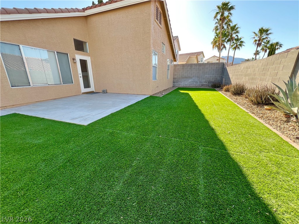 9708 Ridge Creek Place Las Vegas, NV 89134 - Photo 29 of 34 Green artificial turf with an ample concrete patio and desert-friendly landscaping.
