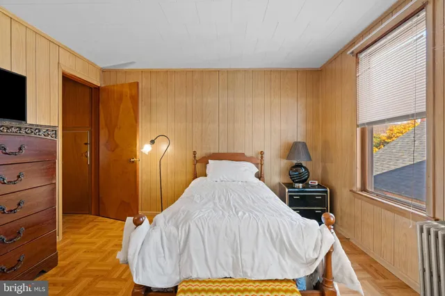 a bed sitting in a bedroom next to a window