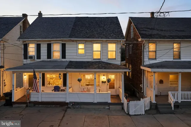 a view of a brick house with many windows
