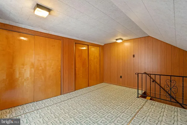 a view of a room with wooden floor and windows