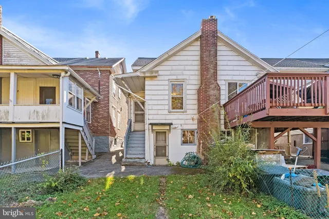 a view of a house with brick walls and a yard