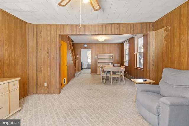 a living room with furniture a dining table and chairs