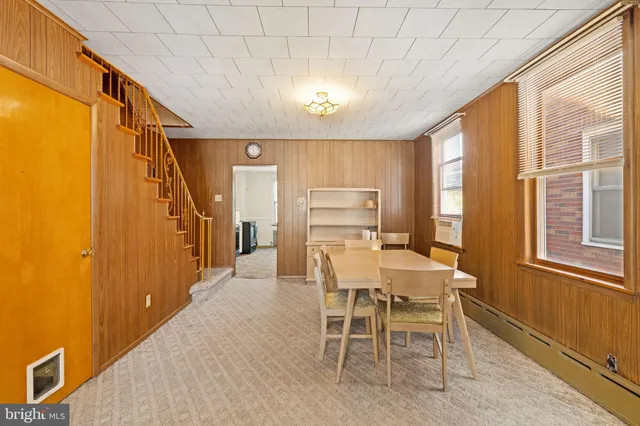 a dining room with furniture and window
