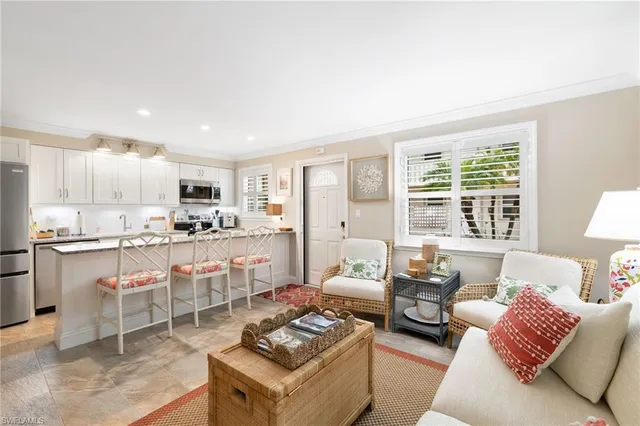 a living room with furniture and kitchen view