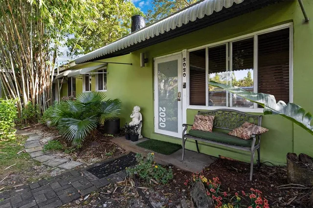 a view of a house with a backyard and sitting area