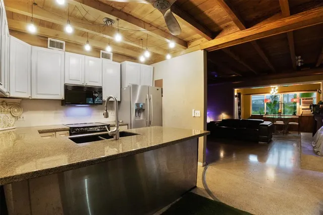 a kitchen with a sink a stove and a microwave